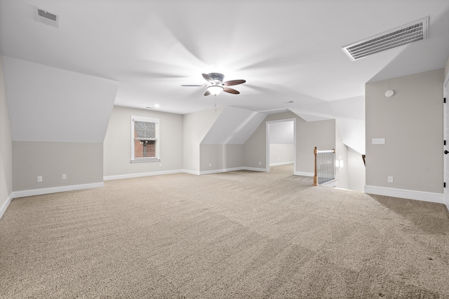 additional living space featuring ceiling fan, light carpet, and vaulted ceiling