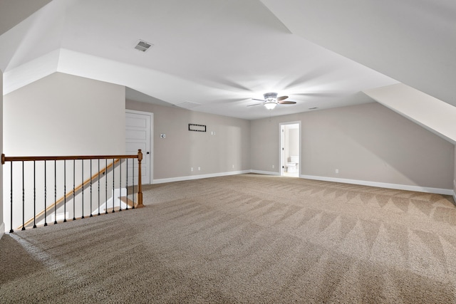 additional living space featuring ceiling fan, carpet, and vaulted ceiling