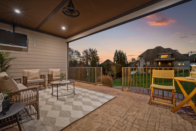 patio terrace at dusk featuring an outdoor living space