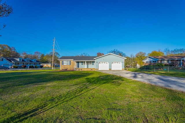 single story home featuring a garage and a front yard