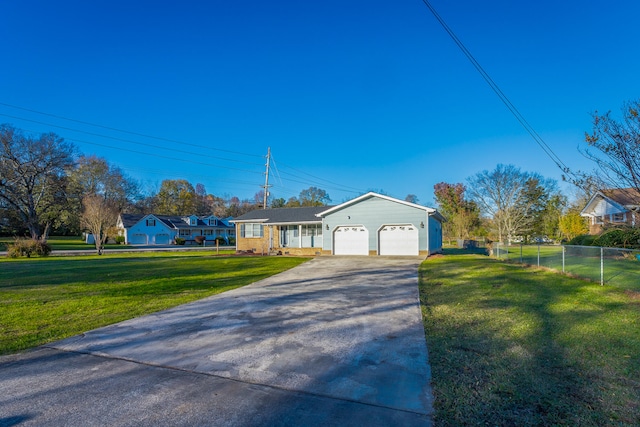 ranch-style house featuring a garage and a front lawn