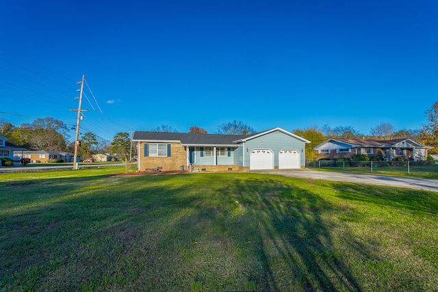 ranch-style home featuring a garage and a front yard