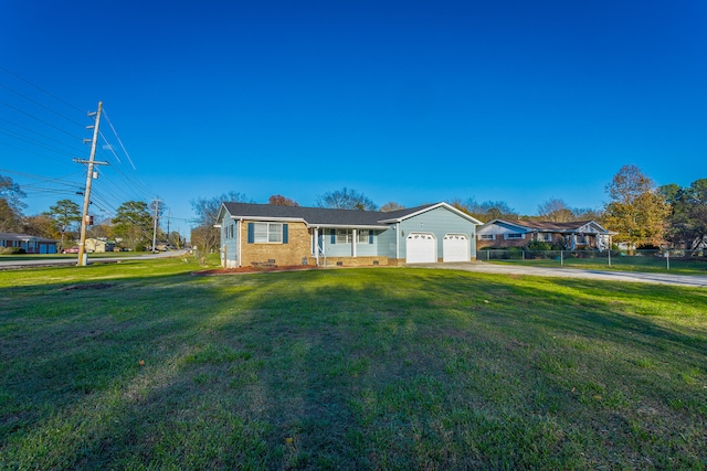 ranch-style house with a garage and a front lawn