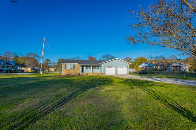 ranch-style home featuring a front yard and a garage