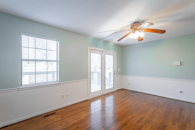 spare room with wood-type flooring, a textured ceiling, and ceiling fan