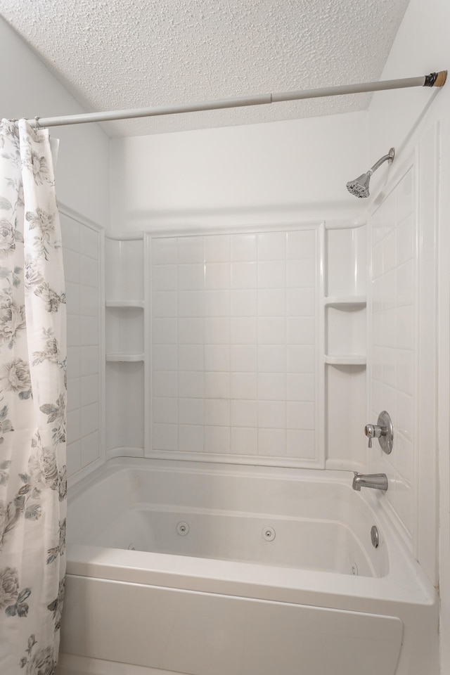 bathroom featuring shower / tub combo and a textured ceiling