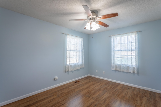 spare room featuring ceiling fan, wood-type flooring, and a textured ceiling