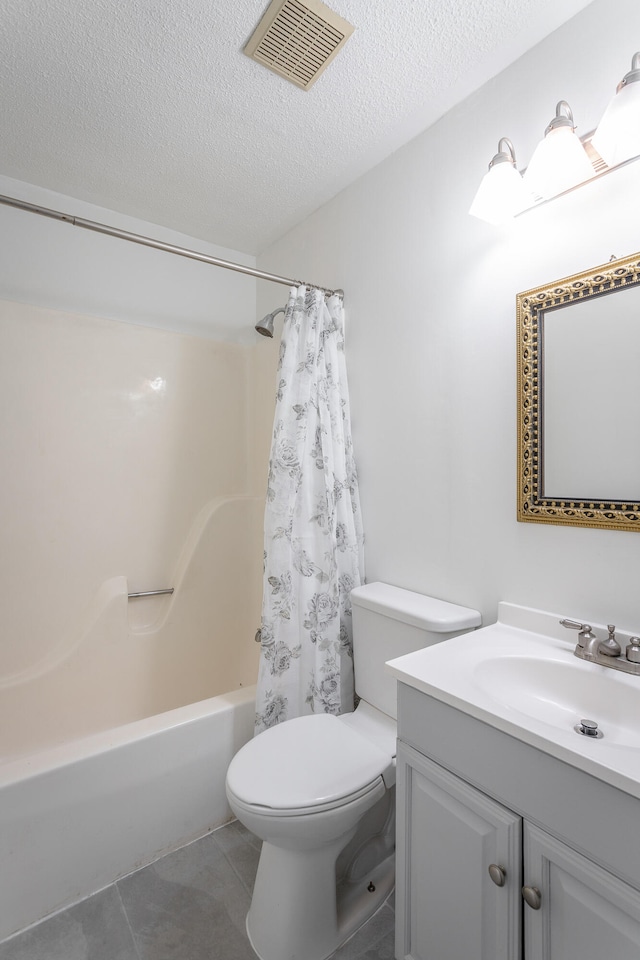 full bathroom featuring shower / bath combo, tile patterned flooring, a textured ceiling, toilet, and vanity