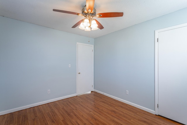 unfurnished room featuring hardwood / wood-style floors, a textured ceiling, and ceiling fan