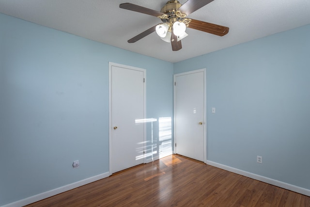 unfurnished room with ceiling fan, wood-type flooring, and a textured ceiling