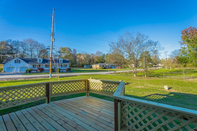 deck with a yard and a garage