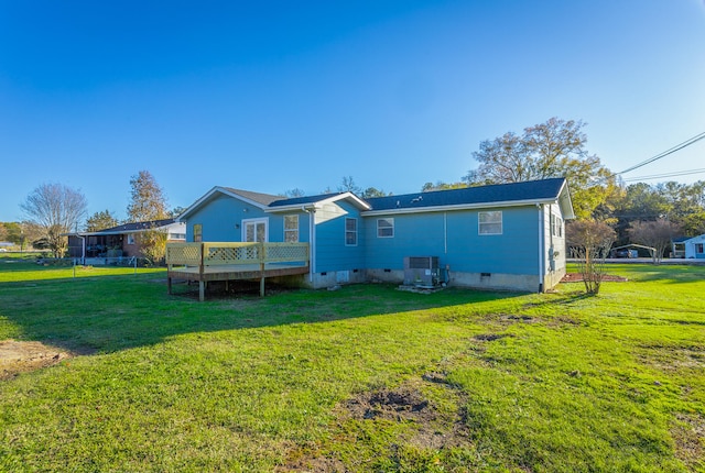 back of house with central AC, a yard, and a deck