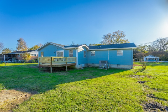 back of property with a lawn, central AC, and a deck