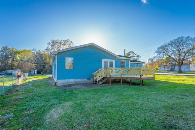 back of property featuring a yard and a wooden deck