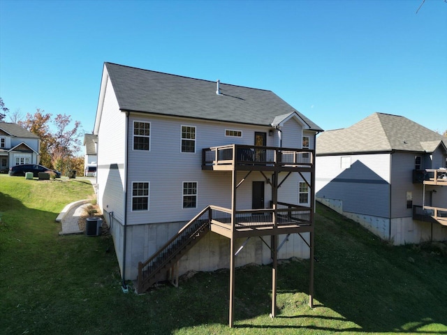 rear view of house featuring central air condition unit, a lawn, and a wooden deck