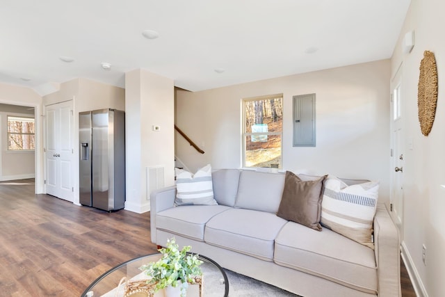 living room featuring dark hardwood / wood-style flooring and electric panel