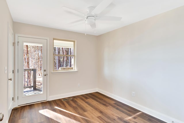 empty room with dark wood-type flooring and ceiling fan