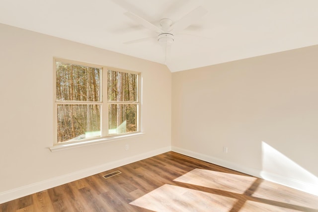 spare room featuring lofted ceiling, hardwood / wood-style floors, and ceiling fan