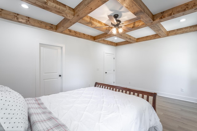 bedroom with beamed ceiling, dark hardwood / wood-style flooring, ceiling fan, and coffered ceiling