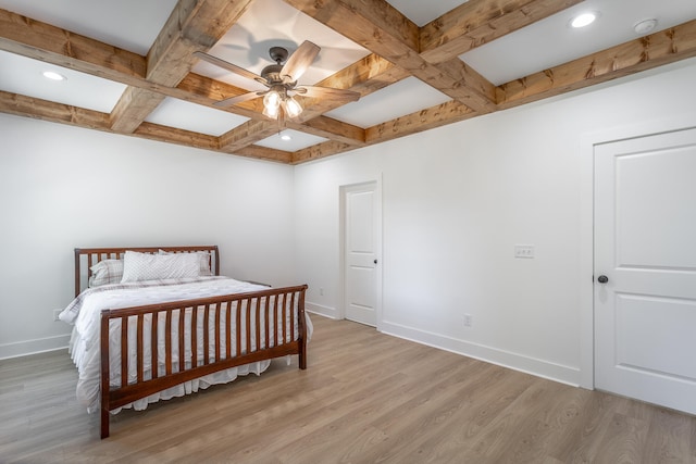 bedroom with beam ceiling, light hardwood / wood-style floors, ceiling fan, and coffered ceiling