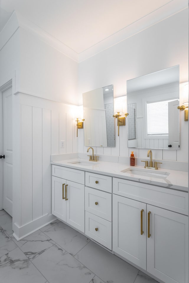 bathroom with crown molding and vanity