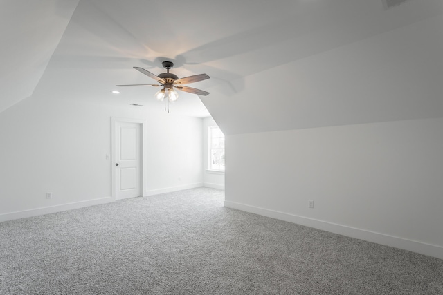 additional living space with carpet flooring, vaulted ceiling, and ceiling fan