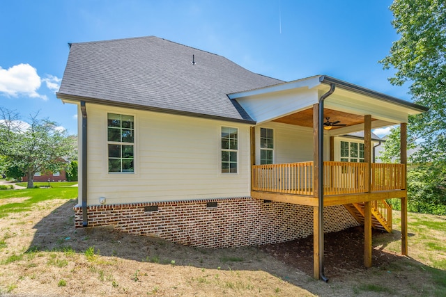 rear view of property with ceiling fan and a wooden deck