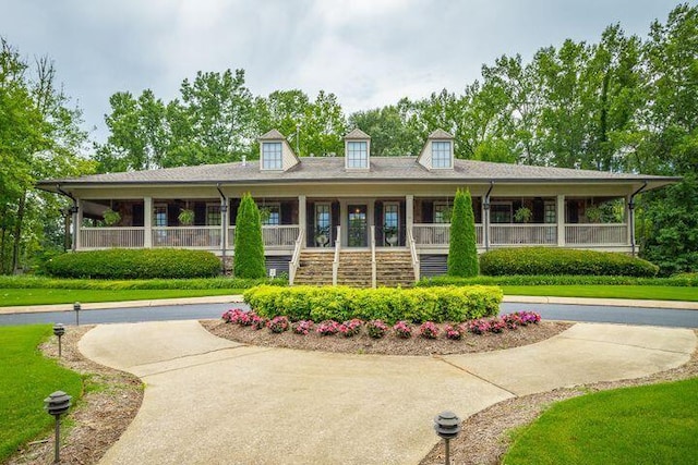 exterior space with covered porch and a front lawn