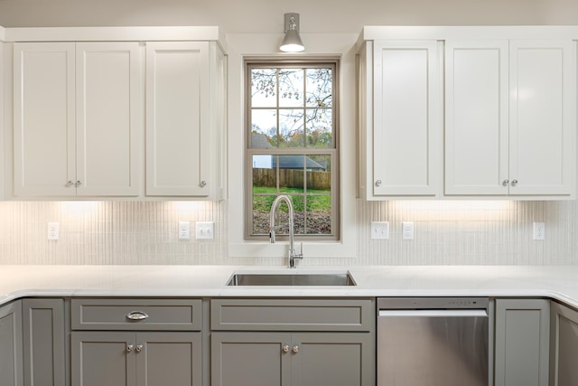 kitchen featuring white cabinets, gray cabinetry, and sink