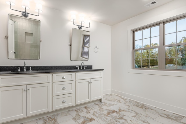 bathroom with a shower and vanity