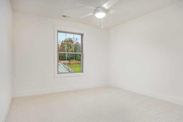 spare room featuring carpet flooring and ceiling fan