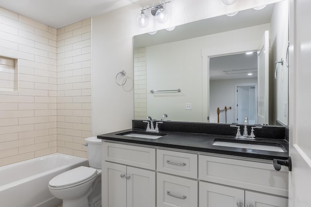 full bathroom featuring vanity, toilet, and tiled shower / bath combo