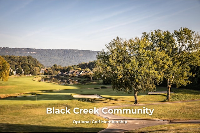 view of community with a lawn and a water view