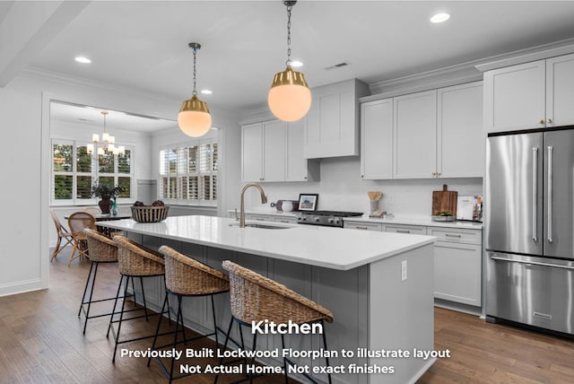 kitchen featuring a kitchen island with sink, sink, dark hardwood / wood-style floors, appliances with stainless steel finishes, and white cabinetry