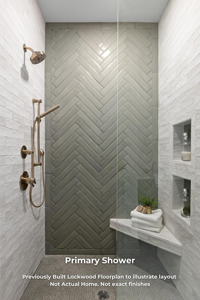 bathroom with tiled shower