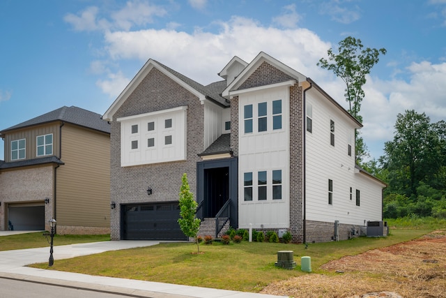 view of front of home with a front yard and a garage