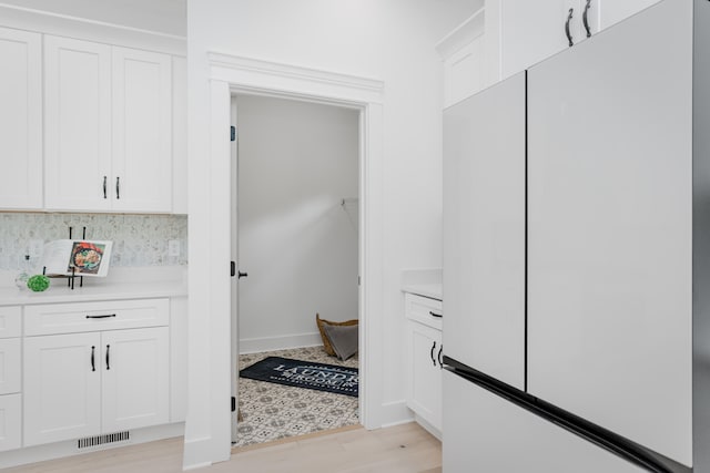 bathroom with vanity, wood-type flooring, and backsplash