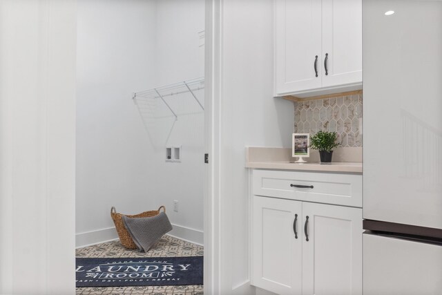 8340 Snowdrop Way, Ooltewah, TN 37363 - laundry room with washer hookup, cabinet space, and baseboards