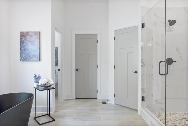 8340 Snowdrop Way, Ooltewah, TN 37363 - full bathroom featuring a marble finish shower, a soaking tub, and baseboards