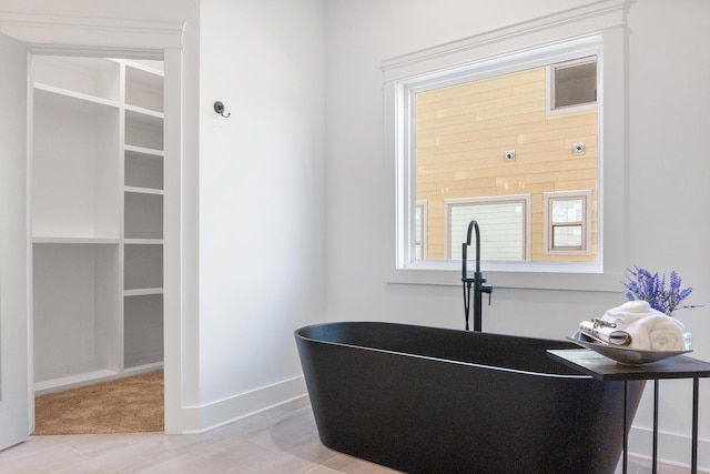 8340 Snowdrop Way, Ooltewah, TN 37363 - detailed view of wood finished floors, a soaking tub, and baseboards