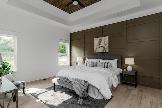 8340 Snowdrop Way, Ooltewah, TN 37363 - bedroom featuring a tray ceiling, wood ceiling, baseboards, and light wood-style flooring