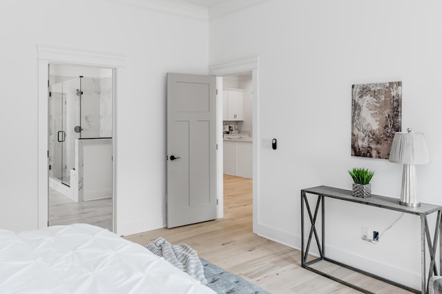 bedroom featuring ornamental molding and light hardwood / wood-style flooring