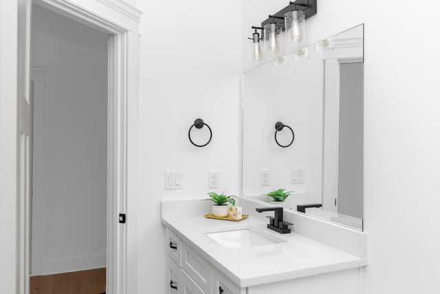 bathroom with hardwood / wood-style floors and vanity