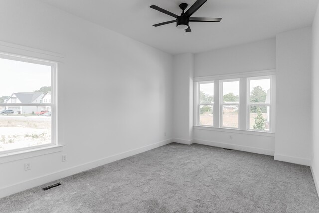 unfurnished room featuring ceiling fan and light colored carpet