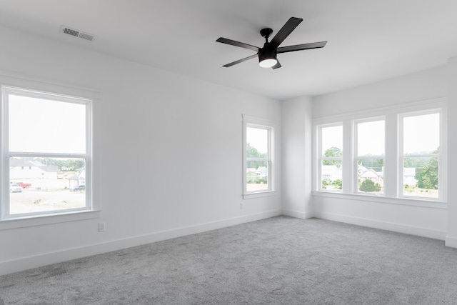 unfurnished room with light carpet, plenty of natural light, and ceiling fan