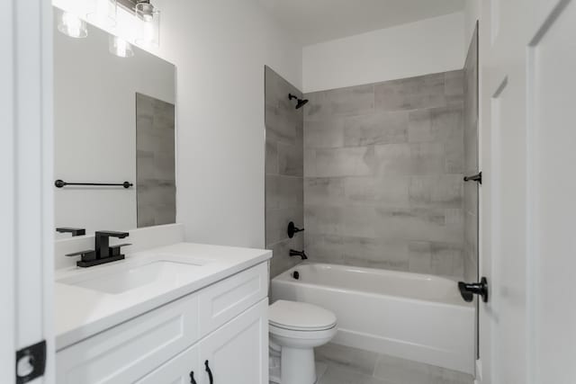 full bathroom with tile patterned flooring, tiled shower / bath combo, toilet, and vanity