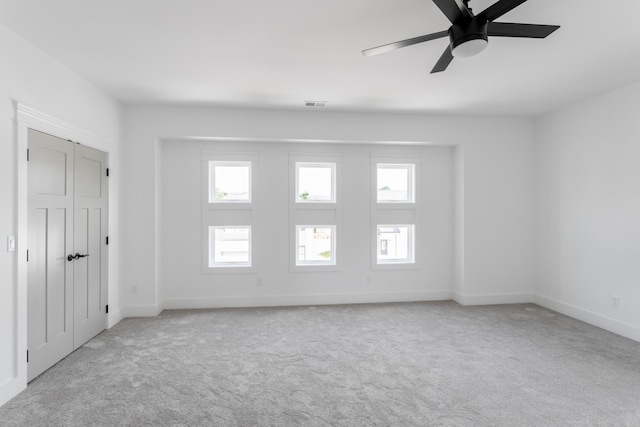 empty room featuring light carpet and ceiling fan