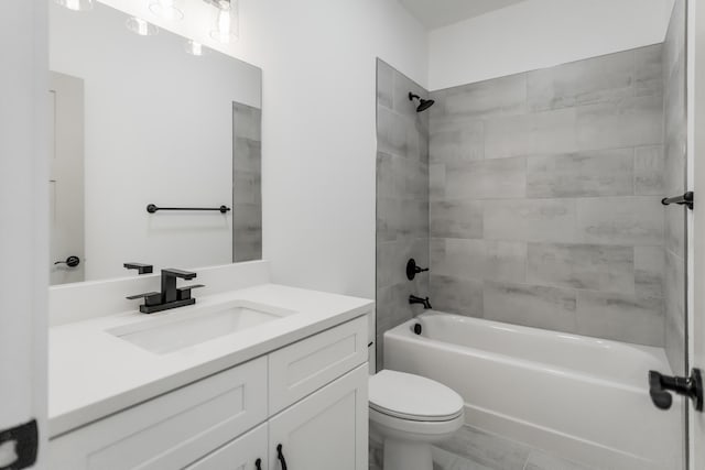 full bathroom with vanity, toilet, and tiled shower / bath