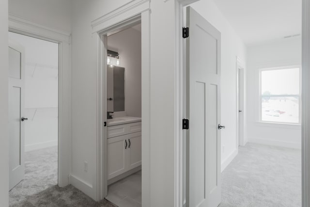 8340 Snowdrop Way, Ooltewah, TN 37363 - hallway featuring light colored carpet, a sink, and baseboards