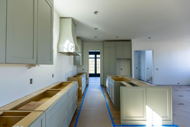 kitchen featuring french doors, light wood-type flooring, premium range hood, and gray cabinetry